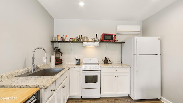 kitchen with white appliances, a wall mounted AC, dark wood-type flooring, sink, and white cabinetry