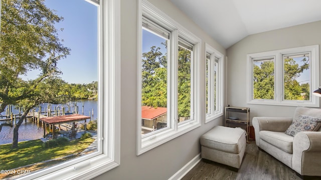 sunroom with a water view and lofted ceiling