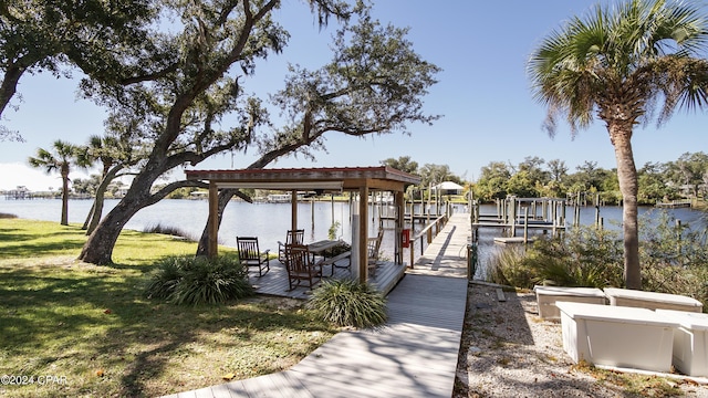 view of dock featuring a water view and a lawn