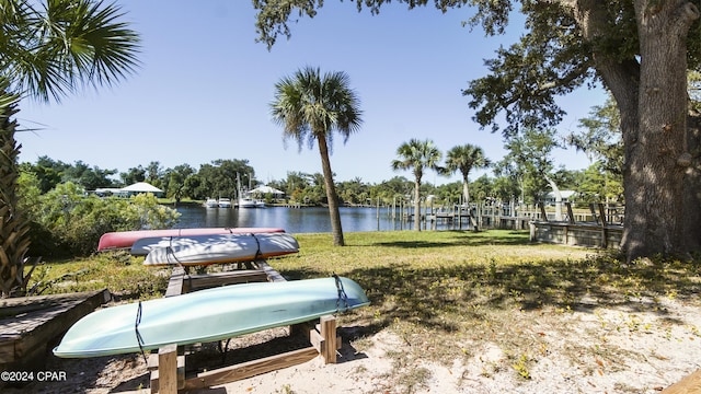 dock area featuring a yard and a water view