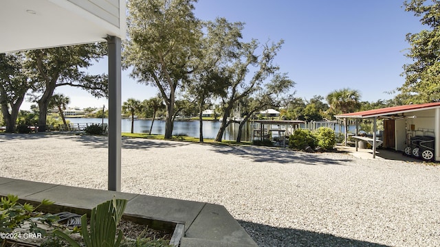 view of yard with a water view and a patio area