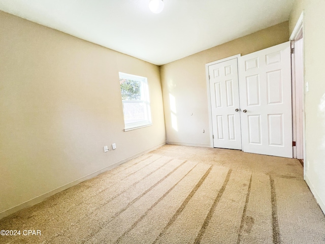 unfurnished bedroom with carpet floors and a closet