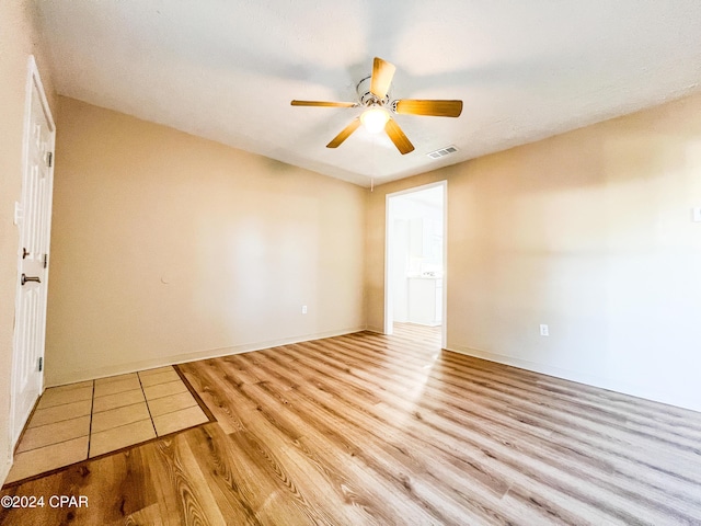 unfurnished room with ceiling fan and light hardwood / wood-style floors