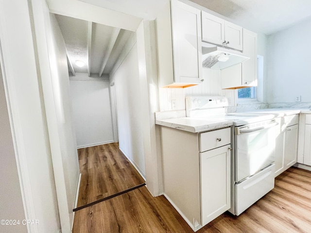 kitchen with white cabinets, stove, light wood-type flooring, and light stone countertops