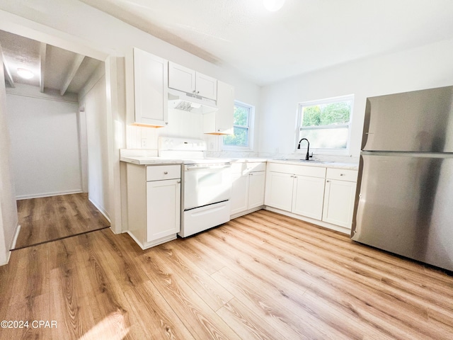 kitchen with stainless steel fridge, white cabinetry, and range