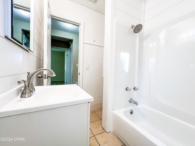 bathroom with tile patterned flooring, bathtub / shower combination, a textured ceiling, and vanity