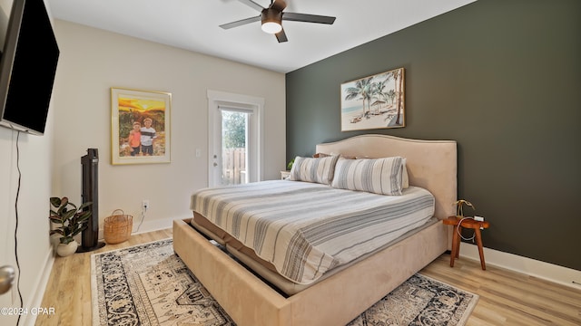 bedroom with access to exterior, ceiling fan, and light hardwood / wood-style floors