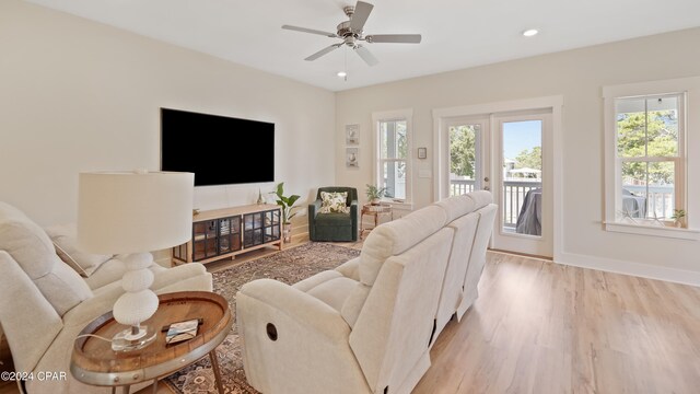 living room featuring ceiling fan and light hardwood / wood-style flooring