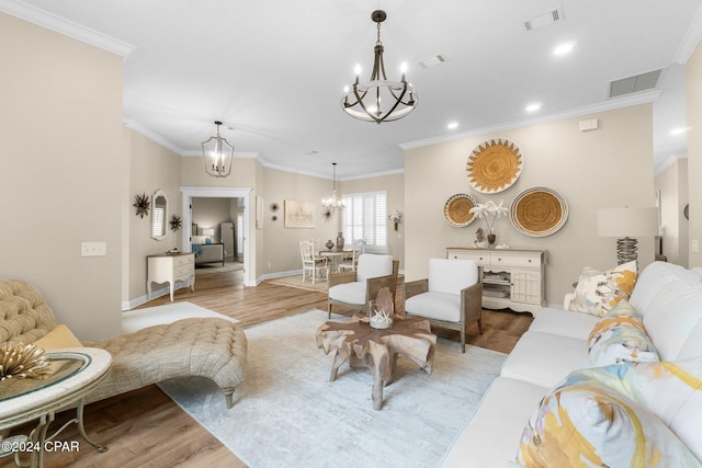 living area with light wood-type flooring, visible vents, and a chandelier