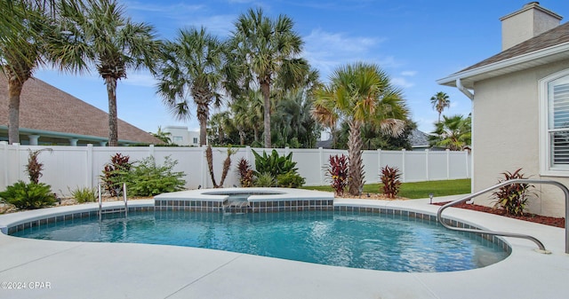 view of swimming pool with an in ground hot tub