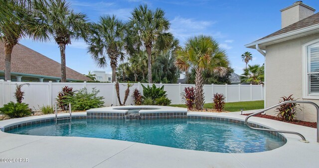 view of swimming pool with an in ground hot tub