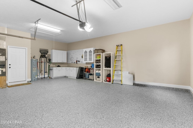 garage featuring water heater, baseboards, and a garage door opener