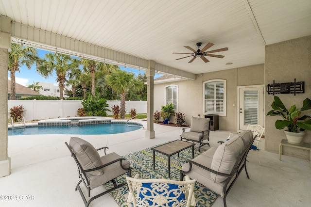 view of pool featuring a fenced in pool, a patio area, ceiling fan, an in ground hot tub, and a fenced backyard