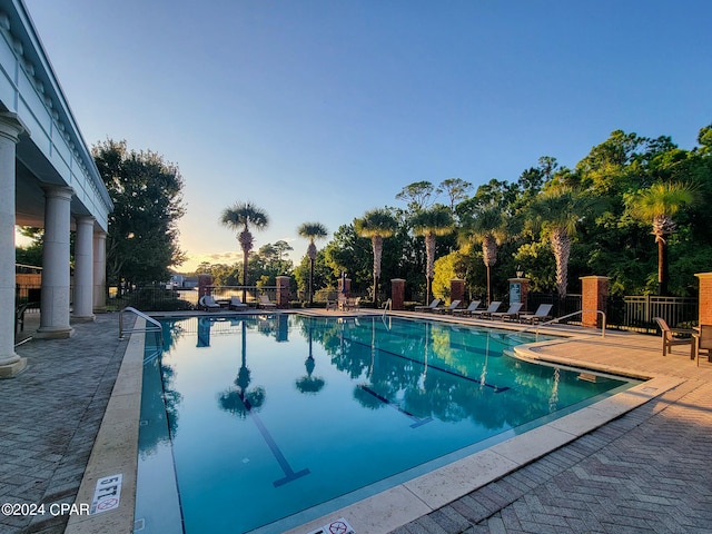 pool at dusk with a patio