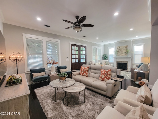 living room featuring ornamental molding, wood-type flooring, and a wealth of natural light