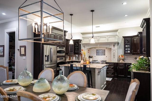 dining room with crown molding, a chandelier, and dark hardwood / wood-style flooring