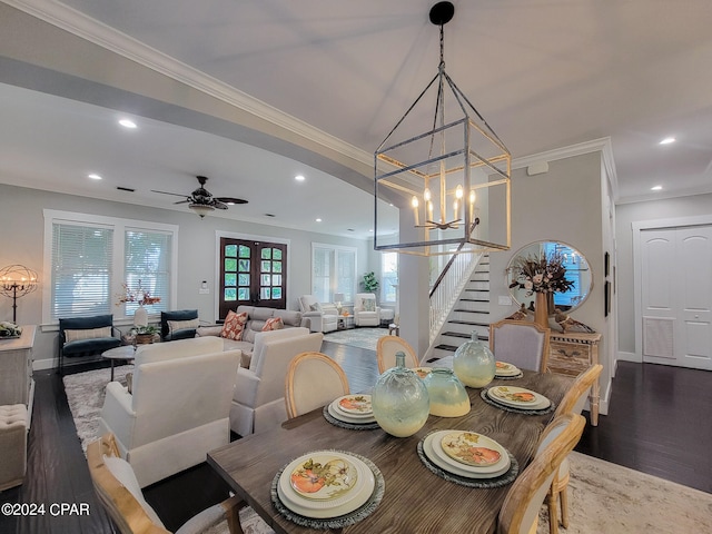 dining area with ornamental molding, dark hardwood / wood-style floors, and ceiling fan with notable chandelier