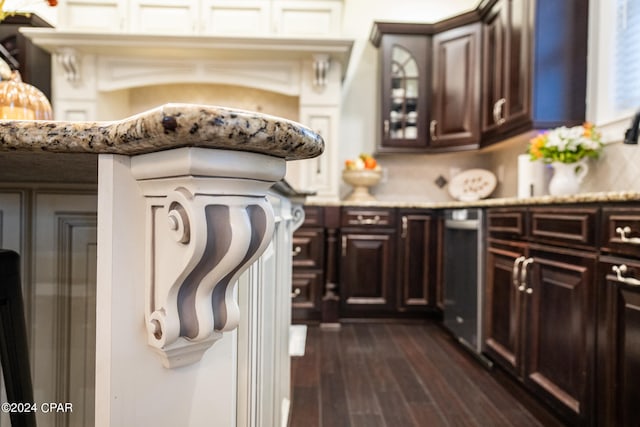 kitchen featuring dark brown cabinetry and dark hardwood / wood-style flooring