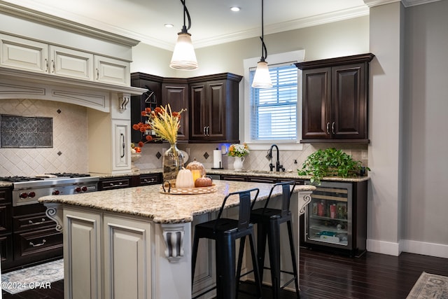 kitchen with tasteful backsplash, dark hardwood / wood-style flooring, a kitchen island, ornamental molding, and dark brown cabinetry