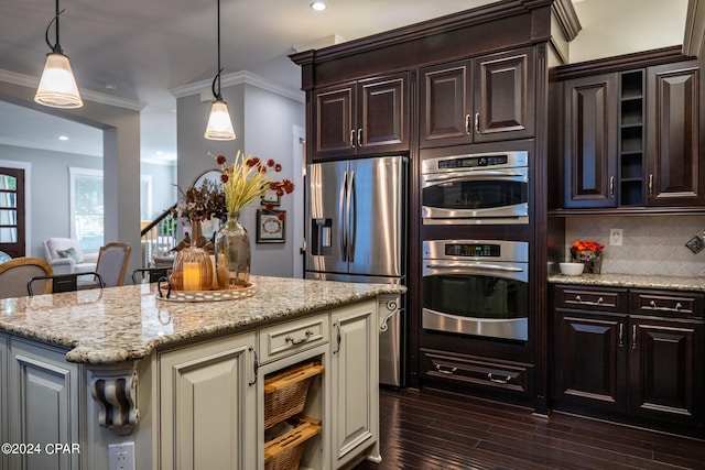 kitchen with backsplash, stainless steel appliances, ornamental molding, and hanging light fixtures