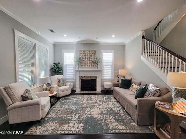 living room featuring dark hardwood / wood-style flooring, ornamental molding, and plenty of natural light