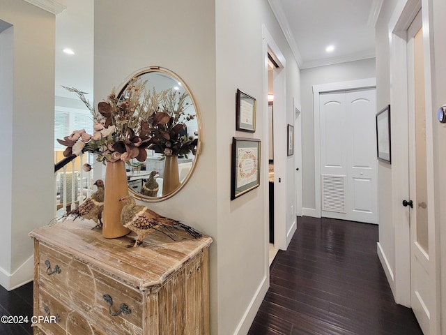 hall featuring ornamental molding and dark wood-type flooring