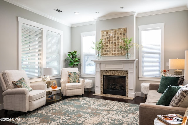 living room featuring ornamental molding, a fireplace, dark hardwood / wood-style floors, and plenty of natural light