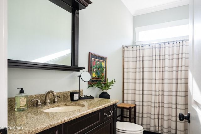 bathroom featuring vanity, a shower with curtain, ornamental molding, and toilet