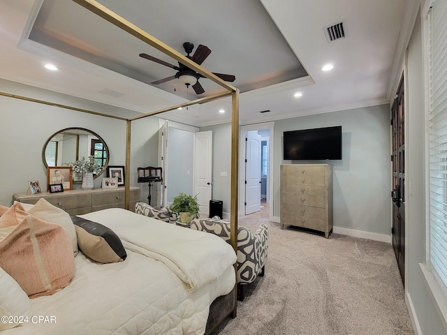 carpeted bedroom featuring crown molding, a tray ceiling, and ceiling fan