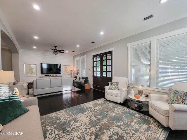 living room featuring french doors, ceiling fan, crown molding, and dark hardwood / wood-style flooring