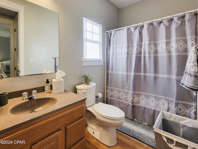 bathroom with vanity, hardwood / wood-style floors, toilet, and walk in shower