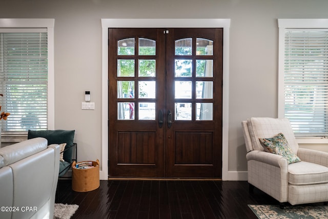 foyer entrance with french doors and dark wood-type flooring