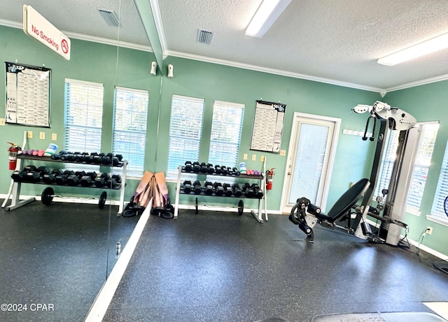 gym with crown molding and a textured ceiling