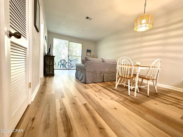 dining space with light hardwood / wood-style floors