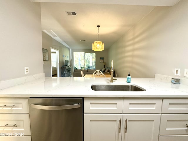 kitchen featuring dishwasher, kitchen peninsula, sink, pendant lighting, and white cabinetry