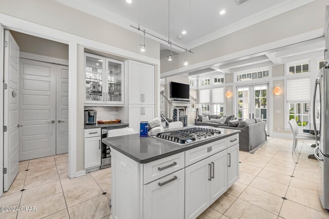 198 E Water St, Inlet Beach, FL 32461 - kitchen with beverage cooler, stainless steel appliances, dark countertops, white cabinetry, and crown molding