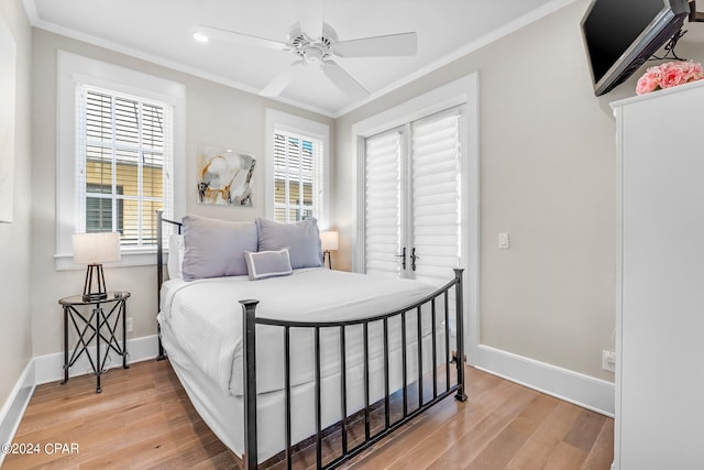 bedroom featuring hardwood / wood-style flooring, ceiling fan, and crown molding