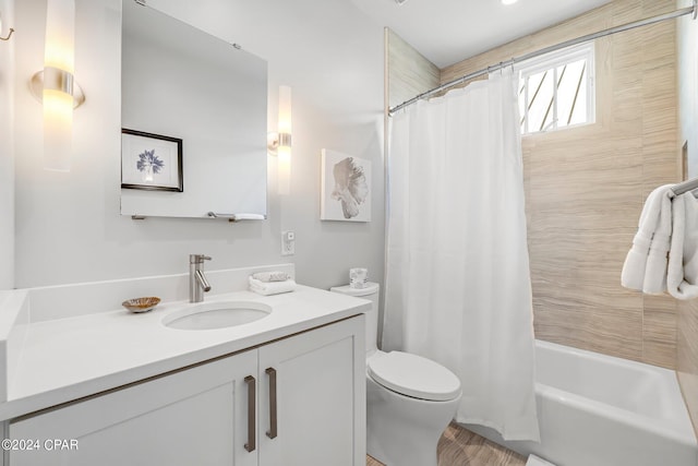 full bathroom with shower / bath combo, vanity, hardwood / wood-style flooring, and toilet