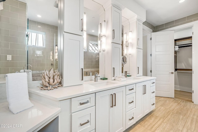 bathroom with hardwood / wood-style floors, vanity, and an enclosed shower