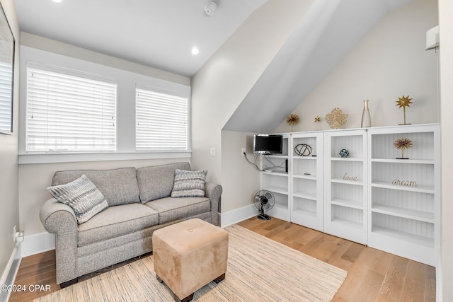 living room featuring hardwood / wood-style floors, plenty of natural light, and lofted ceiling