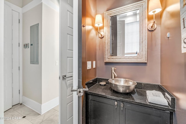 bathroom featuring electric panel and vanity