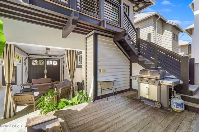 wooden deck featuring an outdoor hangout area, ceiling fan, and grilling area