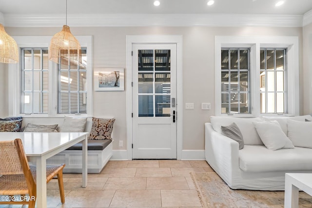 dining area with light tile patterned floors and crown molding