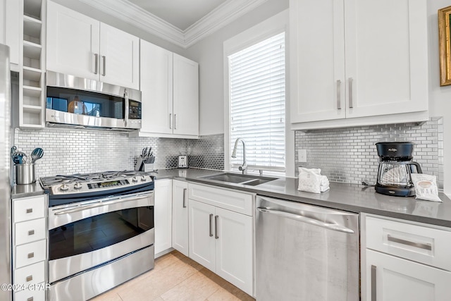 198 E Water St, Inlet Beach, FL 32461 - kitchen featuring appliances with stainless steel finishes, white cabinetry, ornamental molding, plenty of natural light, and backsplash