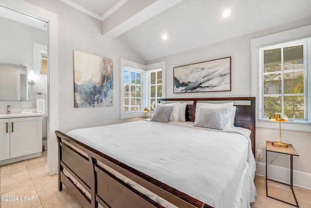 bedroom featuring ensuite bath, crown molding, sink, light tile patterned floors, and lofted ceiling