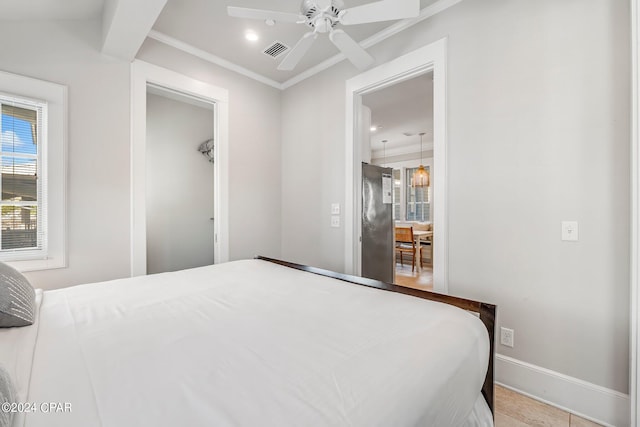 bedroom featuring ceiling fan, light tile patterned flooring, and crown molding