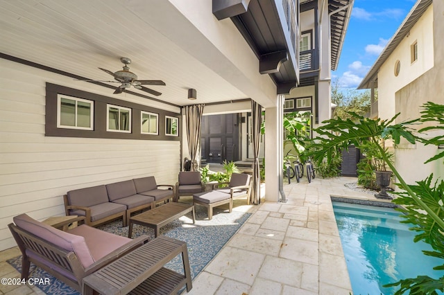 view of patio with an outdoor living space and ceiling fan