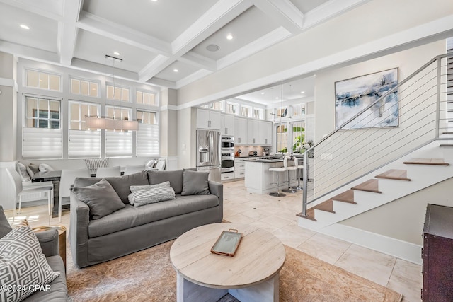 living room featuring beamed ceiling, light tile patterned flooring, a healthy amount of sunlight, and coffered ceiling