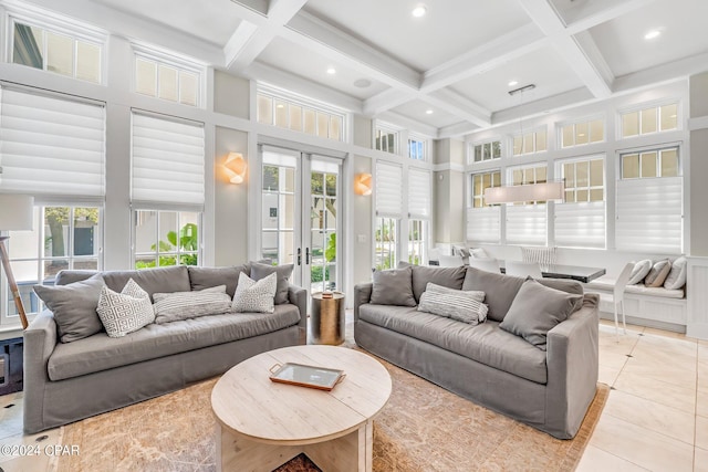 tiled living room with beam ceiling, french doors, a high ceiling, and coffered ceiling