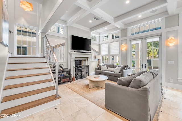 tiled living room with french doors, a towering ceiling, coffered ceiling, and beam ceiling